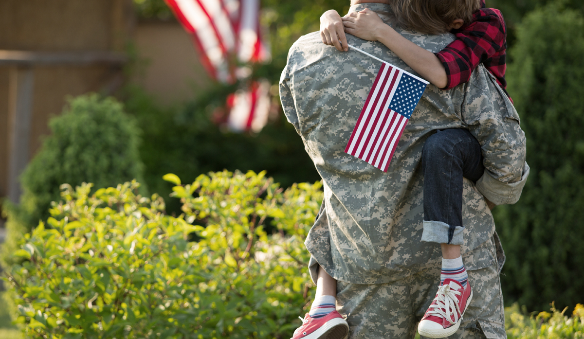 A young child greets a Veteran parent returning home
